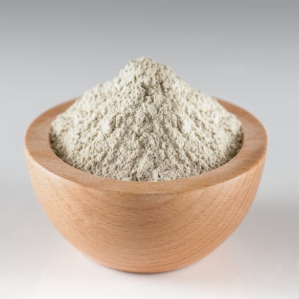 Fine milled natural bentonite powder in a bowl, used in civil engineering and industrial sealing applications